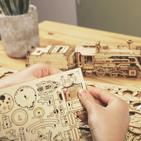 Hands assembling Wooden Model Car Kit For Adults A Fun Hands On 3D Puzzle Build That Doubles As Brain Teaser Desk Decor And DIY Hobby Gift