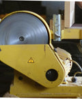 Industrial machine with yellow casing and caution sticker, part of 24 Pack Caution Stickers For Equipment And Factory Safety Signs Decals