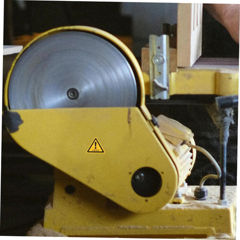 Industrial machine with yellow casing and caution sticker, part of 24 Pack Caution Stickers For Equipment And Factory Safety Signs Decals