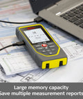 DISTO X6 P2P Laser Range Finder Kit With 800 Ft Reach Point To Point Measuring Bluetooth Data Transfer on blueprints beside laptop