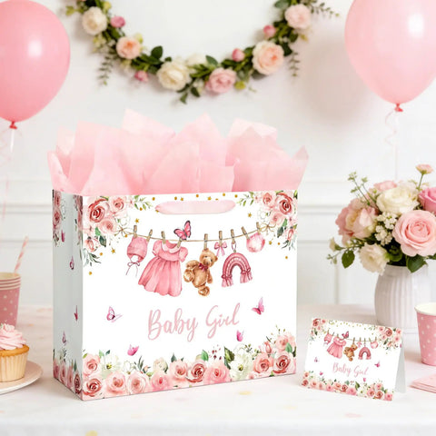 13 Inch Pink Floral Baby Gift Bag With Sturdy Handles Includes Matching Card And Three Sheets Of Tissue Paper on table