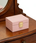 Rock Solid Lockable Metal Box Latches Gold Surface Mount Snap Fasteners on a pink wooden jewelry box for secure storage.