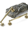 Premium Brass Cabinet Pull And Drawer Knob Set With Modern Grooved Base Design Available In Antique Brass Gold And Chrome Finishes For Kitchen, Bathroom, And Closet Hardware 2 Pack displayed on stone