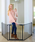 Expandable Extra Wide Baby Gate For Kids And Pets Fits 30 To 90 Inches In Black shown in a wide doorway with mother and baby