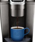 Kick Up Your Morning Routine With This Dope Single Serve Coffee Maker Featuring K Cup Compatibility Strong Brew And Iced Settings Programmable Temp Control Plus Multiple Cup Sizes In Solid Brushed Slate brewing coffee into a blue mug.