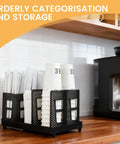 Paper Cup And Lid Holder With Straw Organizer for countertop coffee station, black, fits 8 oz to 22 oz cups, shown in kitchen.