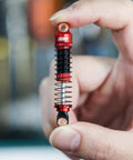 Threaded Shock Absorber Oil Damper 53mm for Redcat Ascent18 held in hand, showing dual springs and CNC aluminum body