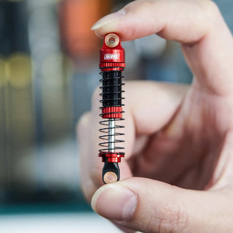 Threaded Shock Absorber Oil Damper 53mm for Redcat Ascent18 held in hand, showing dual springs and CNC aluminum body