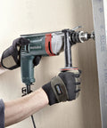 Heavy Duty One Half Inch High Torque Drill With Solid Six Point Seven Amp Motor and Wide Speed Range From Zero To Six Hundred Fifty Rpm in use on a job site.
