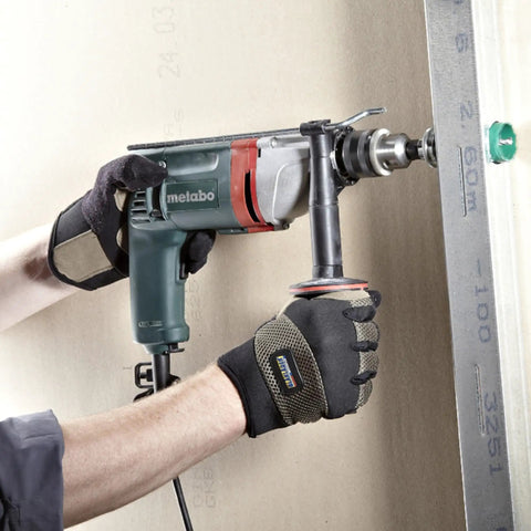 Heavy Duty One Half Inch High Torque Drill With Solid Six Point Seven Amp Motor and Wide Speed Range From Zero To Six Hundred Fifty Rpm in use on a job site.