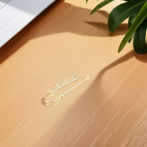 Top Shelf Loop Safety Pin Brooch Set Of Twenty Pieces Electroplated In Rich Golden Tone For Sweaters Coats And Jackets Featuring Reliable Non Slip Clasp To Keep Your Threads Secure on wooden surface.