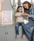 Woman and child interacting in a modern kitchen setting