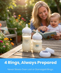 Rock Solid Replacement Collar Rings For Baby Bottles Secure Screw Lids No Spill Nipple Seals BPA Free on a table with bottles.