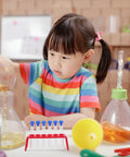 Child conducting experiment with Red Plastic Six Hole Test Tube Rack And Holder For Upright Tubes Burette Stand Secure Lab