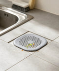 ACDANC 2 Pack Drain Cover Hair Catcher Pad, Silicone Tube Trap placed over kitchen sink, filtering food debris.