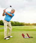 Golfer practicing swing using Golf Putting Mirror With Acrylic Mat And Alignment Guide For Stroke Correction on grass.