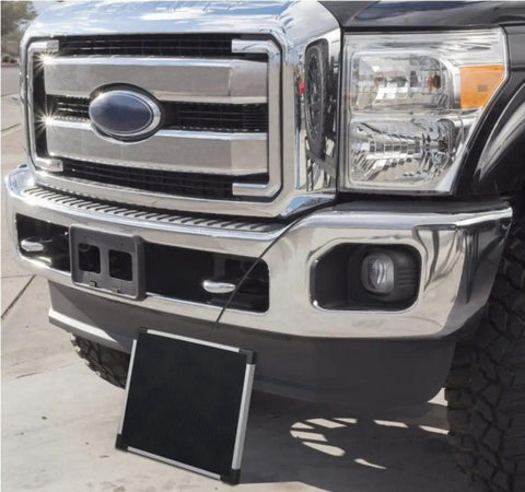 Heavy Duty Five Watt Solar Battery Trickle Charger With Overcharge Guard mounted on a truck front bumper.