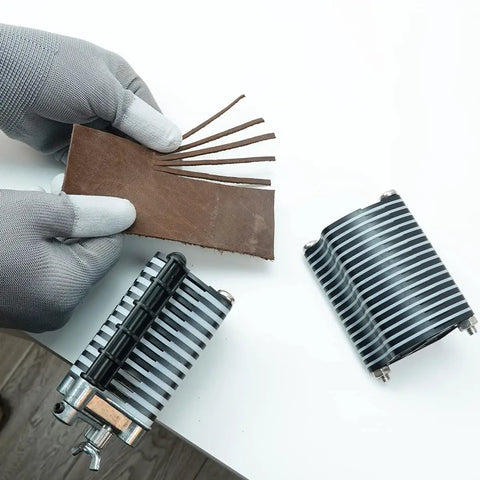 Person using Pro Grade Leather Tabletop Fringe Cutter for lace belts and strips with leather piece and blades visible.