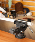 Universal Bench Vise Clamp On Tool With 3.15 Inch Jaw And 360 Degree Swivel Base in use securing a pipe for cutting