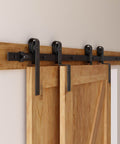 Heavy Duty 8 Foot Sliding Barn Door Hardware Kit For Double Wooden Doors With Single Track And Bypass Floor Guide Black Powder Coated Carbon Steel Construction Supports Up To 330 Lbs Easy Install Smooth Glide And Durable Track installed view