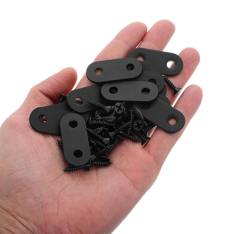 Hand holding black metal plates and screws from Beefy Heavy Duty Iron Corner Brackets Set, Thickened Flat Shelf Braces For Cabinets And Warehouse Racks.
