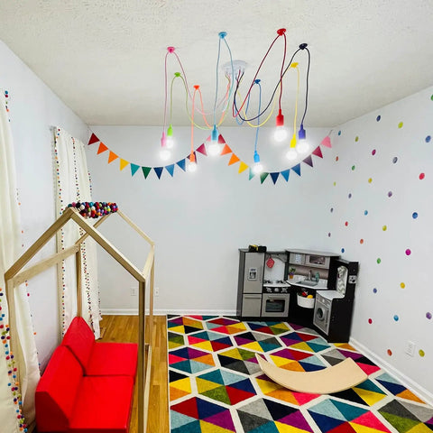 Colorful eight-arm spider pendant light chandelier for kids room with adjustable wires, multicolor finish, E26 base installed on ceiling.