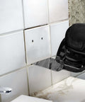 EZARC diamond oscillating blade, side view, flush-cut grout removal between white ceramic tiles