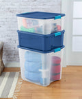 Heavy Duty Clear Plastic Storage Bins Twelve Pack With Tight Latch Lids And Solid Grip Handles For Hella Roomy Home Organization stacked with blankets.