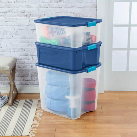 Heavy Duty Clear Plastic Storage Bins Twelve Pack With Tight Latch Lids And Solid Grip Handles For Hella Roomy Home Organization stacked with blankets.