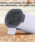 All In One Portable Dryer For Shoes And Threads With Hand Warmer Foldable Design Smart Timing 600W High Power Perfect For Home Travel Or Dorm Living Anywhere, compact design on wooden surface with features displayed