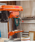 Iron Mortise Converter Runs Tight On Bench Drills, orange drill press with hollow chisel bits setup for precision layouts.