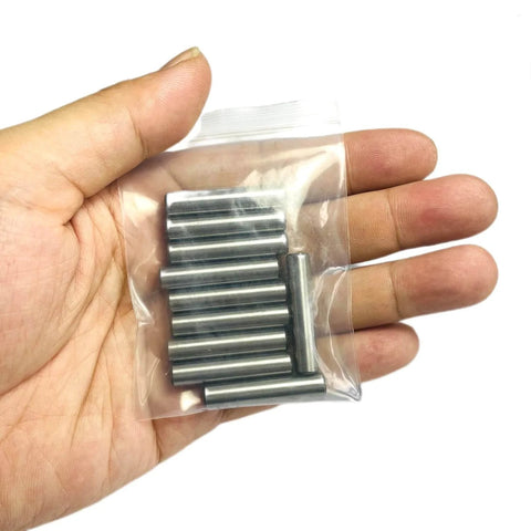 Hand holding pack of Quarter Inch By One And One Quarter Inch Dowel Pins 10 Pack, Metal Shelf Pegs For Shelves And Supports in bag