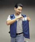Man wearing Top Shelf Big And Tall Cooling Vest For Work Heavy Duty Heat Relief Jacket Pure Cotton Safety Shell, accessing pocket.