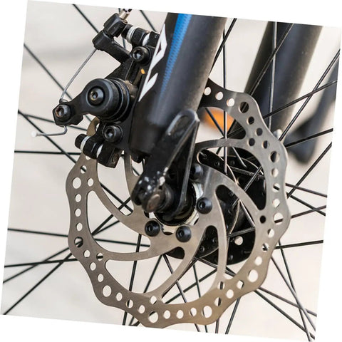 Heavy Duty Front And Rear Mechanical Disc Brake Pad Upgrade For Mountain Bikes Featuring Forged Aluminum Frames And Chunky Sintered Pads For Killer Stopping Power Easy Tweaks And Dependable Trail Performance All Around - close-up of front mechanical disc brake with aluminum caliper and sintered pad.