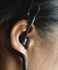 Close up of Listen Only 3.5mm G Shape Earbud Earpiece With Over Ear Hook fitted on ear, adjustable for left or right ear fit.