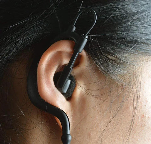 Close up of Listen Only 3.5mm G Shape Earbud Earpiece With Over Ear Hook fitted on ear, adjustable for left or right ear fit.