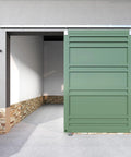 12 Foot Heavy Duty Galvanized Steel Exterior Sliding Barn Door Hardware Kit For Outdoor Use With 450 Lb Capacity And Black Powder Coated Anti Corrosion Finish Installed On Green Door