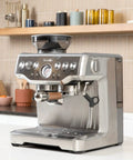 Breville espresso machine with bottomless 54mm portafilter, walnut handle, stainless steel in a modern kitchen setting
