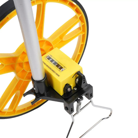 Close-up of Badass Mechanical Measuring Wheel With Slick Foldable Carry Handle For Hella Accurate Indoor And Outdoor Distance Tracking showing yellow wheel and counter.