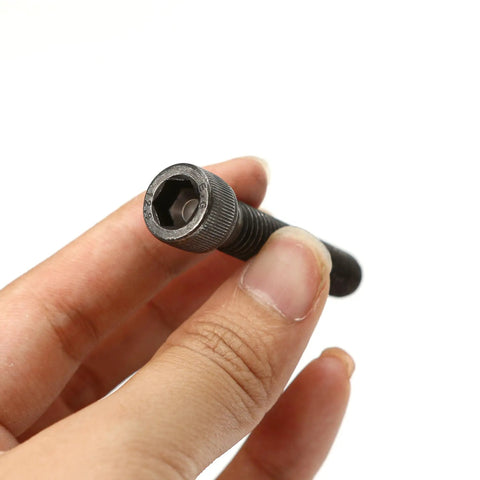 Fifty Pack Beefed Up Socket Head Cap Bolts 3/8X2 Inch Alloy Steel Bouldering Climbing Holds Mounts For Home Gyms Easy Rigging showing a hand holding a bolt with hexagonal head.