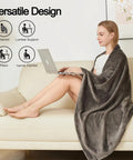 Woman using 2 In Go Everywhere Travel Blanket Pillow Micro Plush Flannel Cozy Compact For Airplane And Car Office And Home Use Ultra Soft Sleep Pillow For Travel Essentials Gray while sitting on a couch with a laptop.