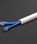 Self Adhesive Cable Raceway For Floors And Walls PVC Wire Channel Cord Cover 98 Ft White Keeps Cords Tidy And Safe No Trip Hazards Easy Install For Home Office Gaming Setup And More showing blue cables inside raceway
