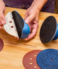 Hands holding 2 Piece Sanding Block Set For 5 Inch Hook And Loop Discs Durable And Versatile For Softening Edges Detail Sanding And Getting More Life Out Of Your Abrasives On Any Orbital Sander with discs