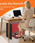 Person using Under Desk Heater Foldable And Quiet Office Space Warmer With Timer 8 Temp Levels Auto Shut Off under a wooden desk