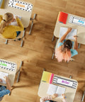 Students at desks with 64 Piece Black And White Scribble Classroom Name Plates Set With Self Adhesive Desk Labels on top.
