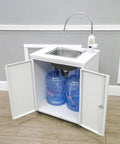 Portable Mobile Hand Wash Station With Hot Water And Temperature Control Self Contained Sink Unit 24x18x39 Inches 110V Power Ideal For Schools Labs Clinics Hospitals Food Trucks Festivals with open cabinet showing water jugs.