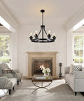 Six Light Farmhouse Wagon Wheel Chandelier for Dining Room with black metal and glass shades above a fireplace