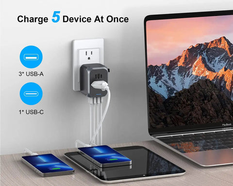 All In One International Travel Plug Adapter With USB C And Four USB Ports charging laptop and devices