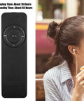 Compact Portable MP3 Player With Lanyard, Expandable Memory Up To 32GB, Rechargeable Battery next to woman using earphones, Black
