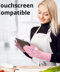 Top Shelf Disposable Nitrile Dish Gloves With Extended 12 Inch Cuff, 6 Mil Thick Guard, Cherry Blossom Print, Latex Free, Straight Up Reliable For Deep Cleaning And Hair Dye, Box Of 100 worn by a woman using a tablet.